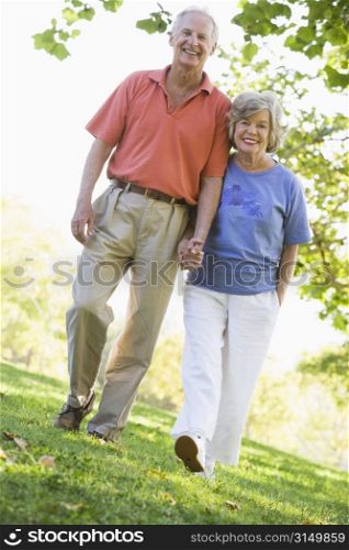 Senior couple walking in park together