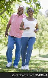 Senior couple walking in park together