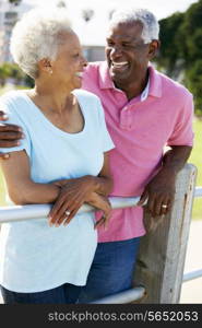 Senior Couple Walking In Park Together