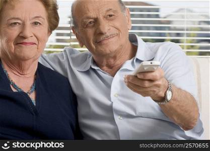 Senior couple watching television