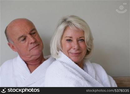 senior couple wearing bathrobes relaxing