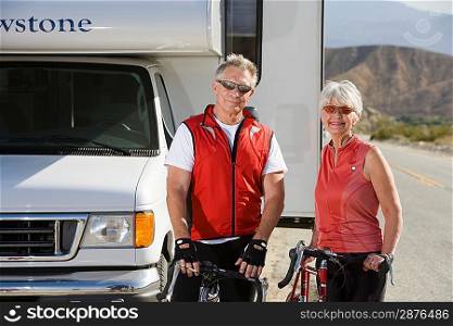 Senior couple with bikes on road