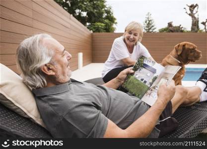 senior couple with dog garden