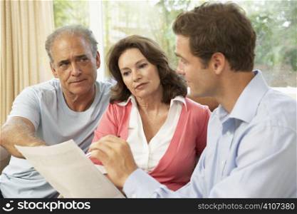 Senior Couple With Financial Advisor At Home