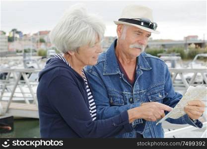 senior couple with map outside