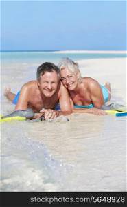Senior Couple With Snorkels Enjoying Beach Holiday