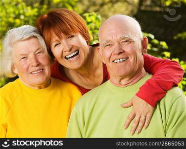 Senior couple with their daughter outdoors