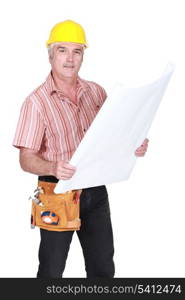 senior craftsman holding a blueprint