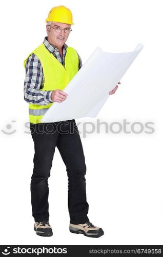 senior craftsman holding a blueprint