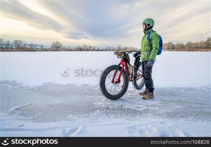 senior cyclist is riding a fat bike in winter, a cold day in Colorado