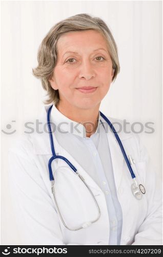 Senior doctor female in white with stethoscope professional portrait