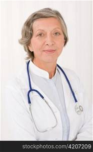 Senior doctor female in white with stethoscope professional portrait
