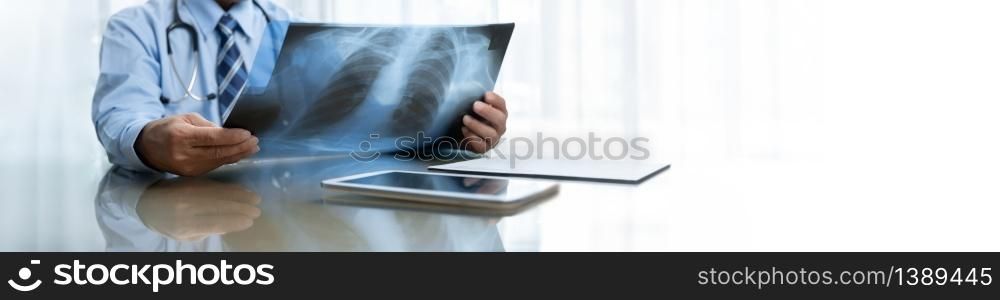 Senior Doctor looking and examining at the X-ray film. Banner, Panoramic.