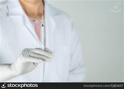 senior doctor or physician hold syringe in the hospital. Concept Of Medical Technology and Healthcare Business