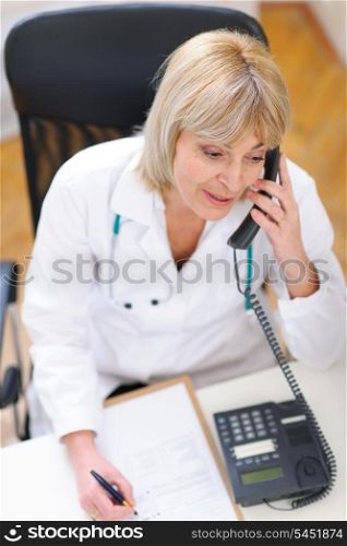 Senior doctor speaking phone