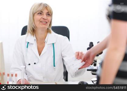 Senior doctor woman giving prescription to patient