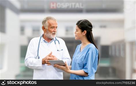 Senior doctor working with young doctor in the hospital. Medical healthcare staff and doctor service.