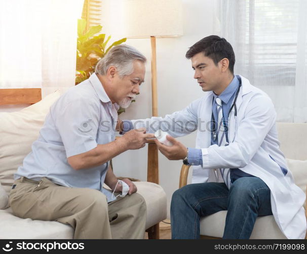 Senior elder asian man asking young caucasian doctor about indications and contraindications of new medicine, healthcare and medicine concept with copy space.