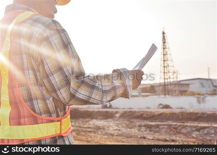 Senior Engineer Checking blueprint construction control management