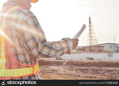 Senior Engineer Checking blueprint construction control management