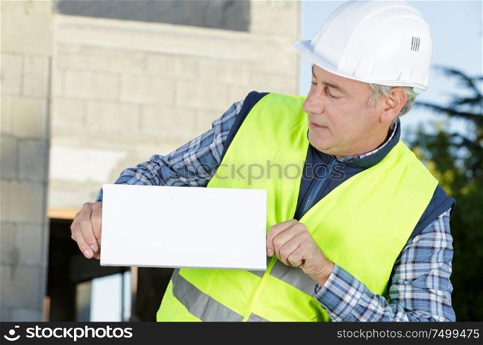 senior engineer man shows a blank board