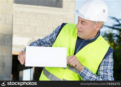 senior engineer man shows a blank board