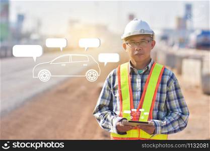 Senior Engineering holding tablet data technology working on road construction site