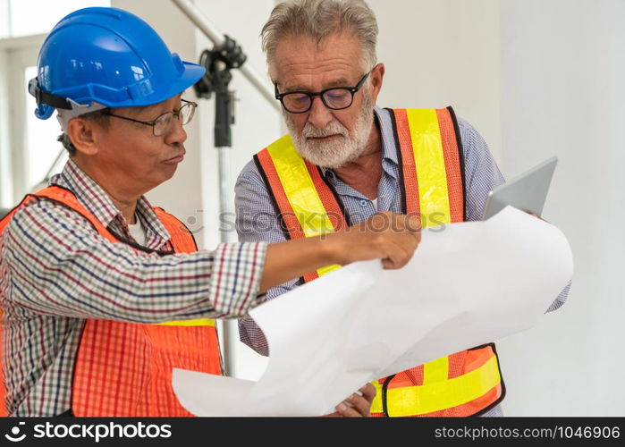 Senior engineers and architect working with construction plan. House building concept.