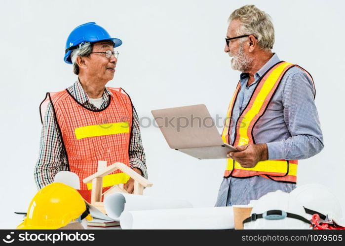 Senior engineers and architect working with construction plan. House building concept.