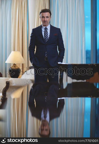 Senior executive businessman at luxury corporate workspace. Portrait of smiling ceo at modern office in stylish suit