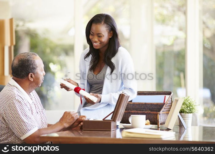 Senior Father Discussing Document With Adult Daughter