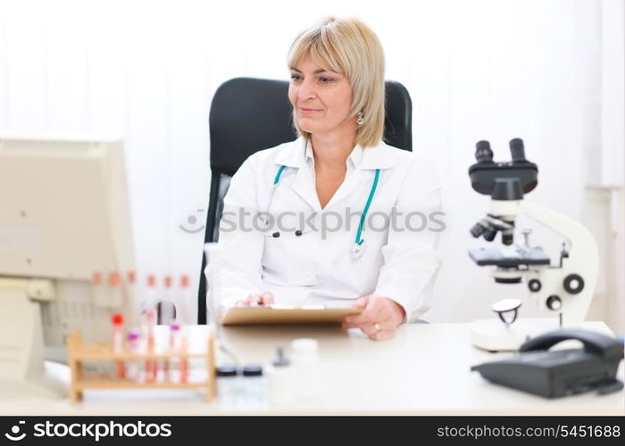 Senior female doctor working at office