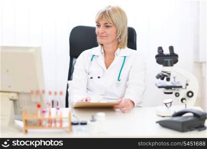 Senior female doctor working at office