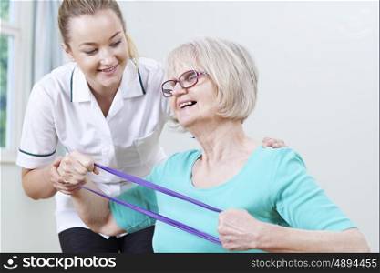 Senior Female Working With Physiotherapist