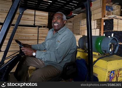 Senior forklift truck driver at warehouse