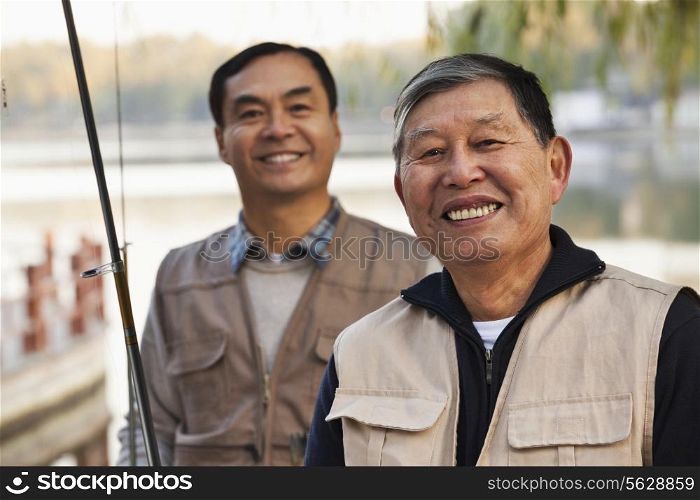 Senior friends portrait while fishing at a lake