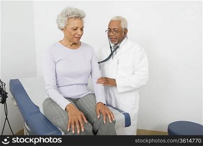 Senior healthcare professional examines female patient