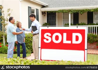 Senior Hispanic couple buying new home