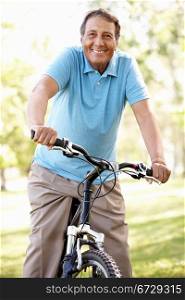 Senior Hispanic man riding bike