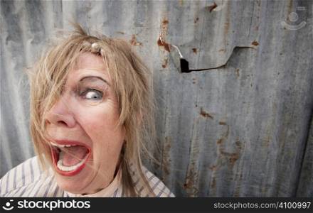 Senior homeless woman with too much makeup screaming