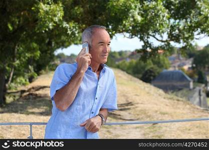 senior in the country talking on his cell phone