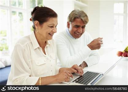 Senior Indian Couple Using Laptop At Home