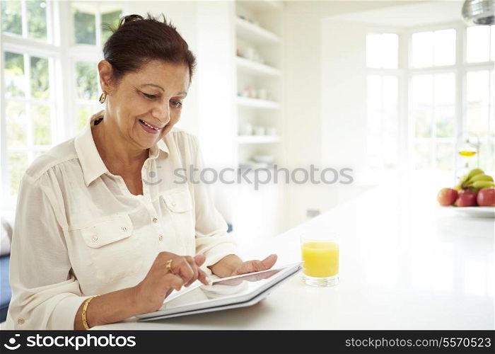Senior Indian Woman Using Digital Tablet At Home