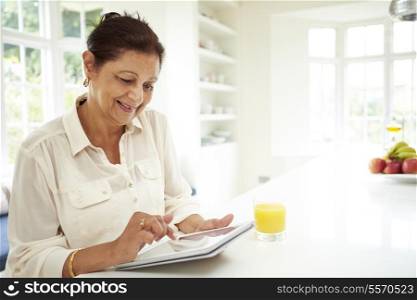 Senior Indian Woman Using Digital Tablet At Home