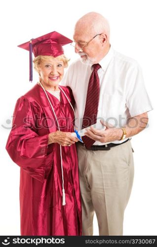 Senior lady and her proud husband celebrate her college graduation. Isolated on white.