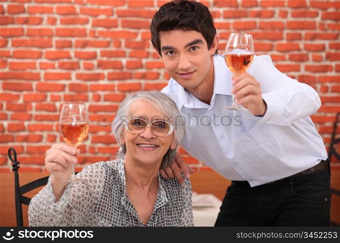 senior lady and young man making a toast