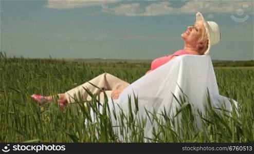 Senior lady enjoying summer holidays on the nature