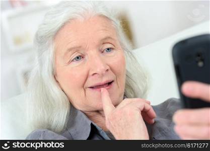 Senior lady reading a text message