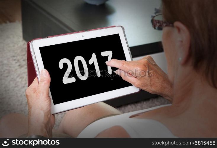 Senior lady relaxing and her tablet - New year - 2017