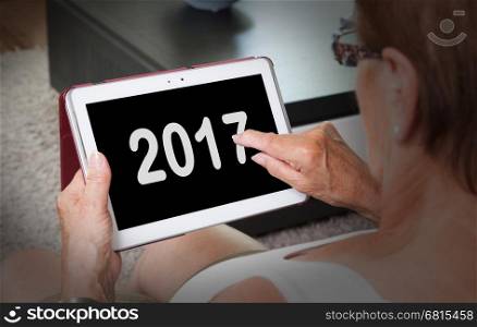 Senior lady relaxing and her tablet - New year - 2017